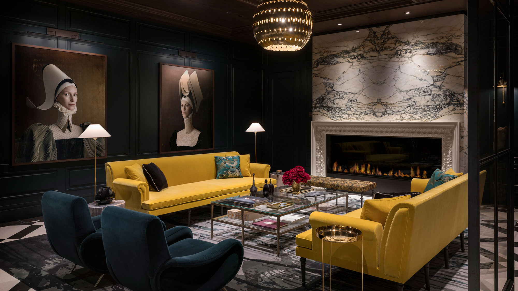A dark and atmospheric lounge with a wide marble fireplace
