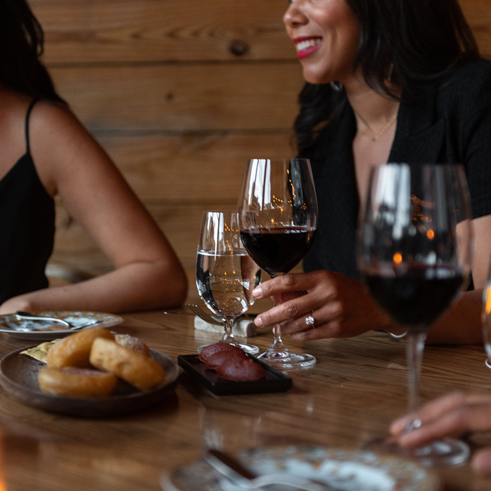 A group of women enjoying glasses of wine at happy hour