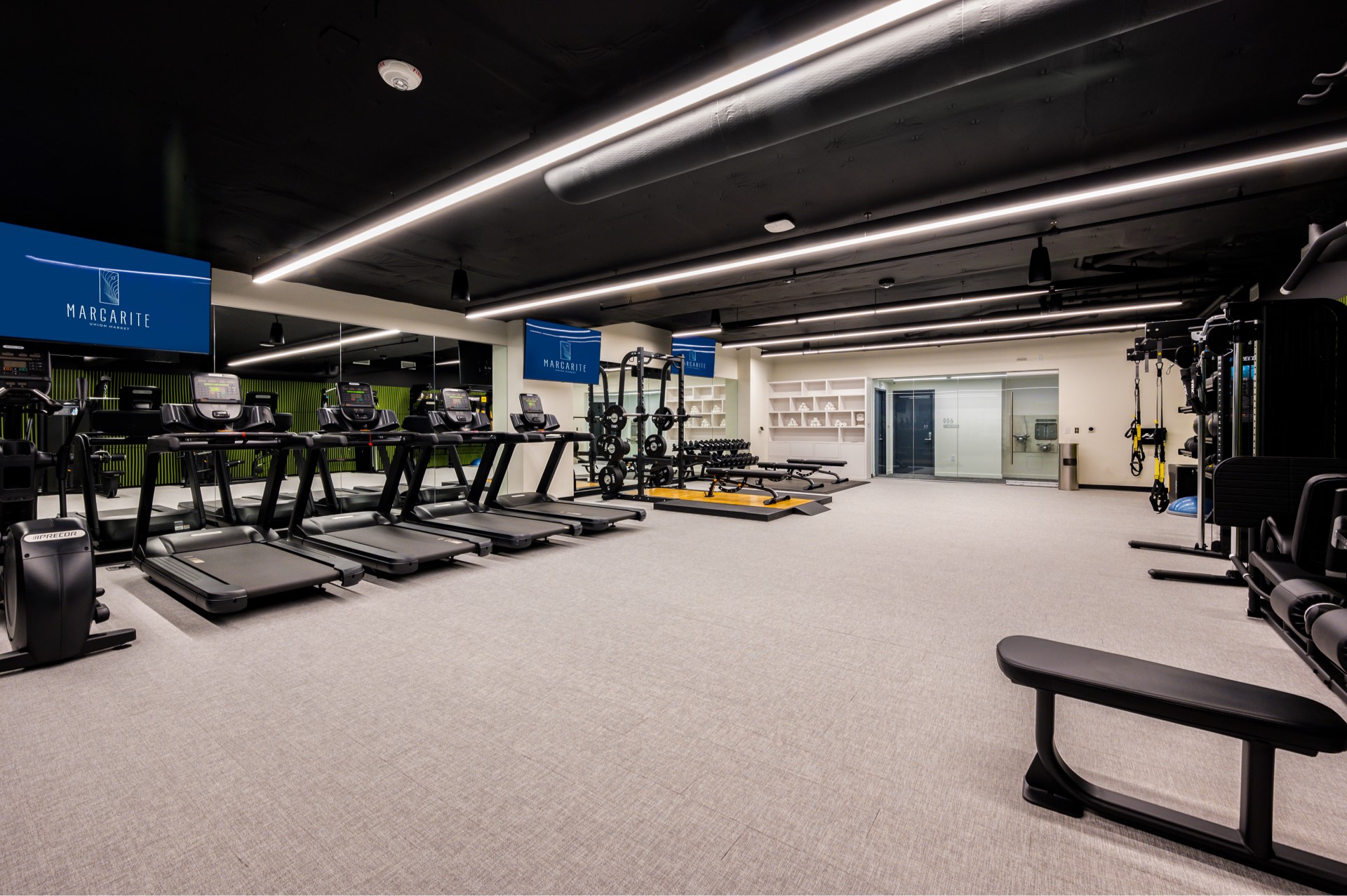 Margarite luxury apartments' fitness center in Washington, DC, with tread machines & a television.