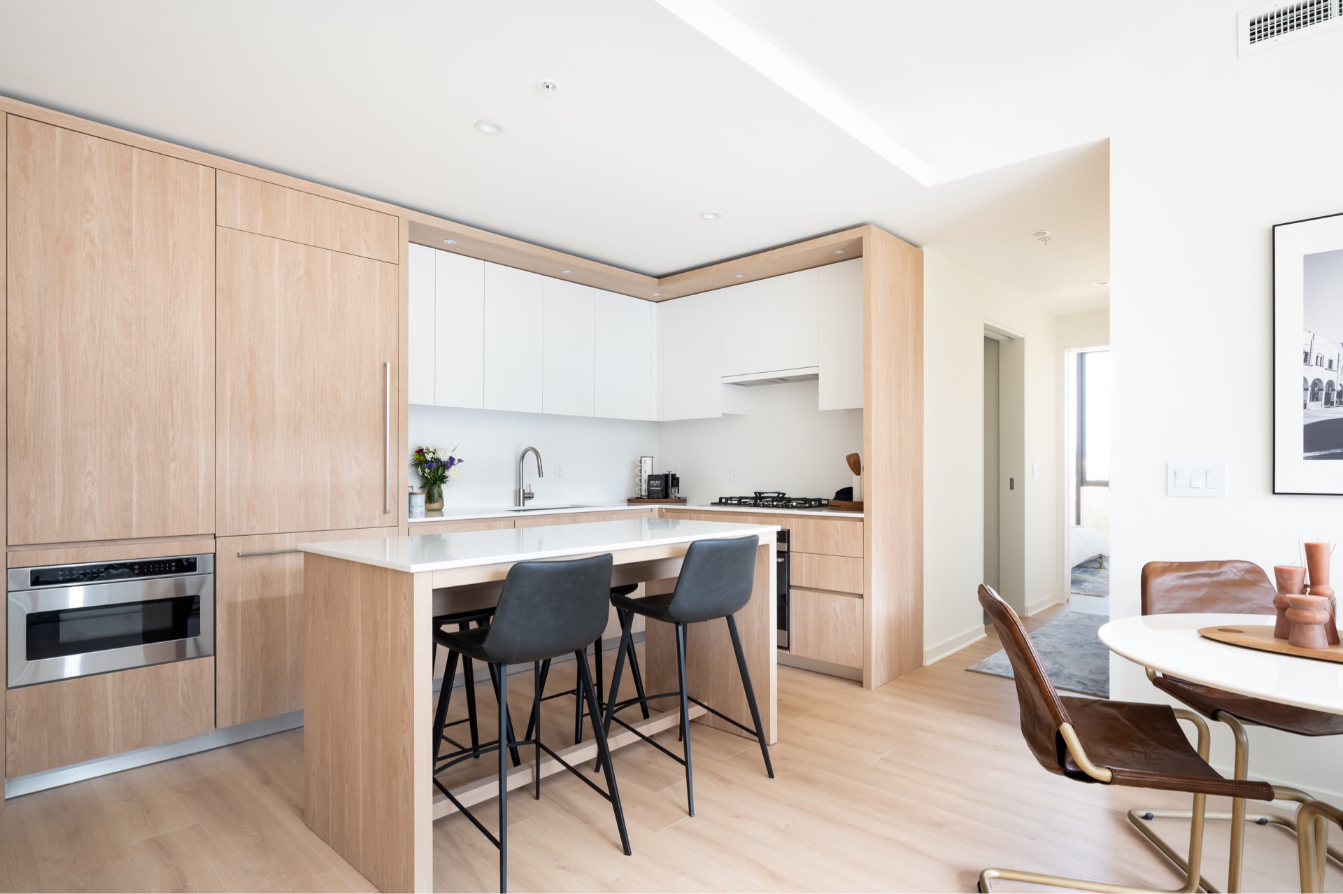 Margarite luxury apartments' kitchen in Washington, DC, with chairs & wooden dining tables.